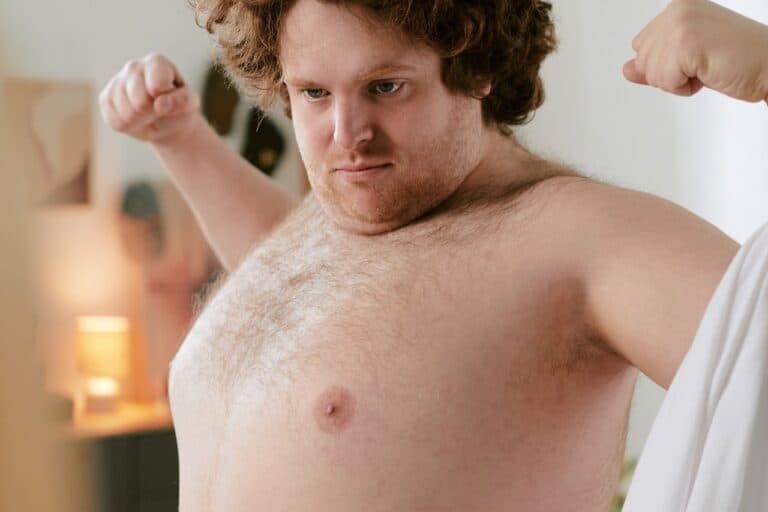 young fat man flexing his arms