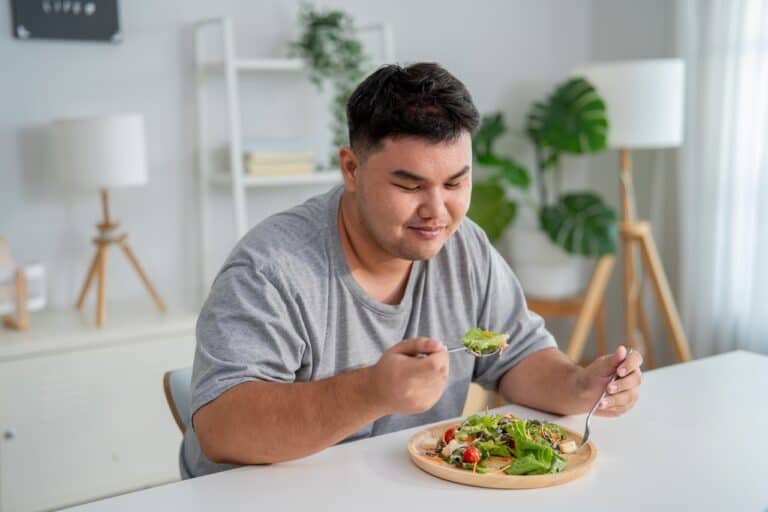 overweight man eating healthy food