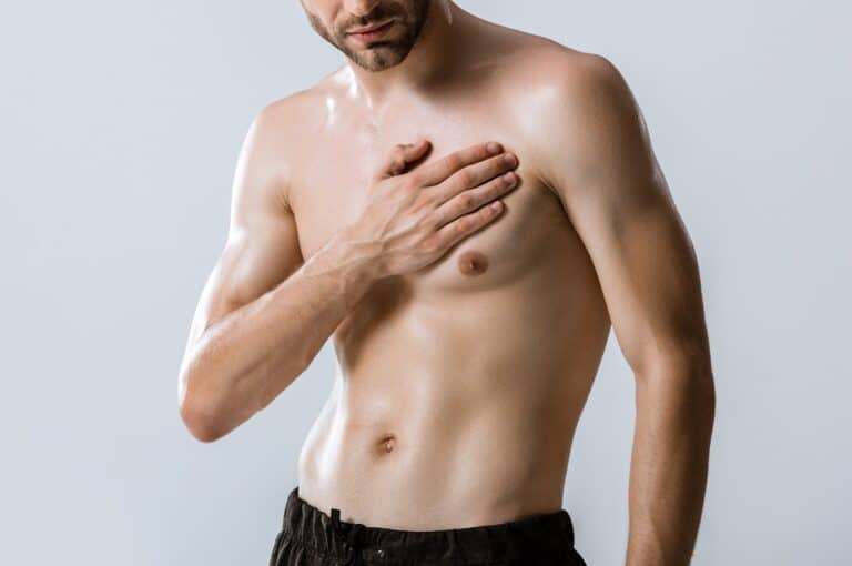 fit healthy man holding chest